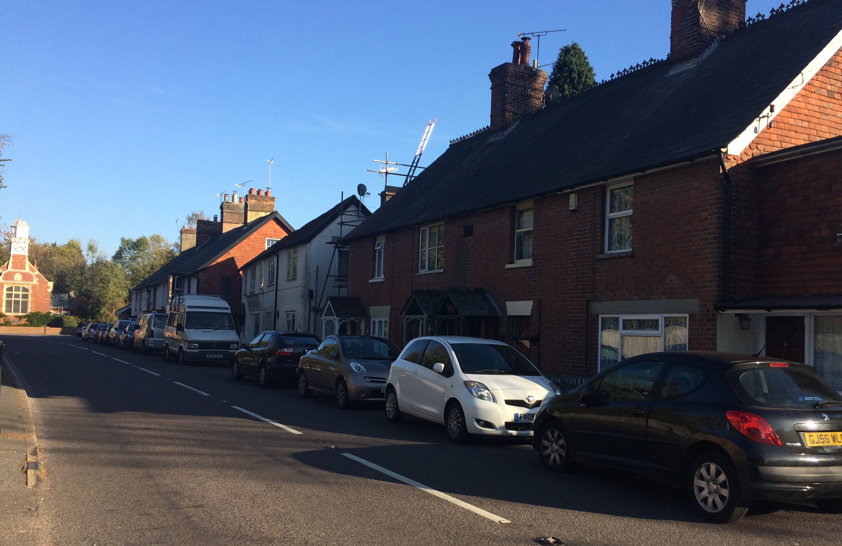 photograph of houses and cars on station road